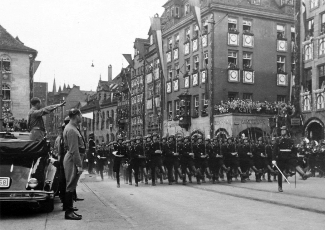Adolf Hitler salutes the parade of the SA in the streets of Nuremberg on the occasion of the Reichsparteitag